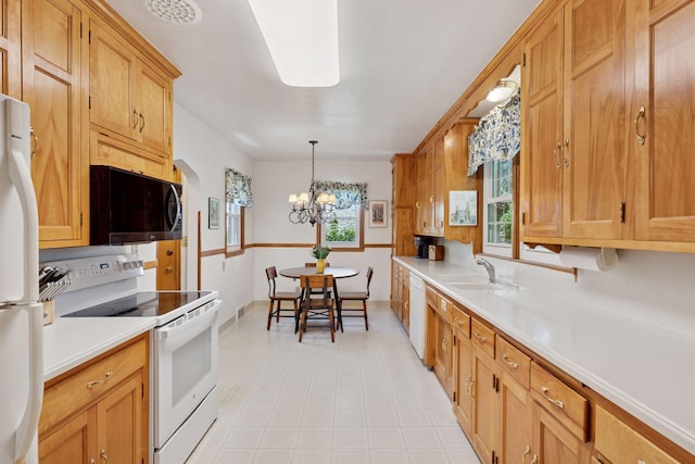1804 Pinehurst Ave, Saint Paul, MN 55116 - kitchen featuring white appliances, light countertops, a chandelier, and pendant lighting