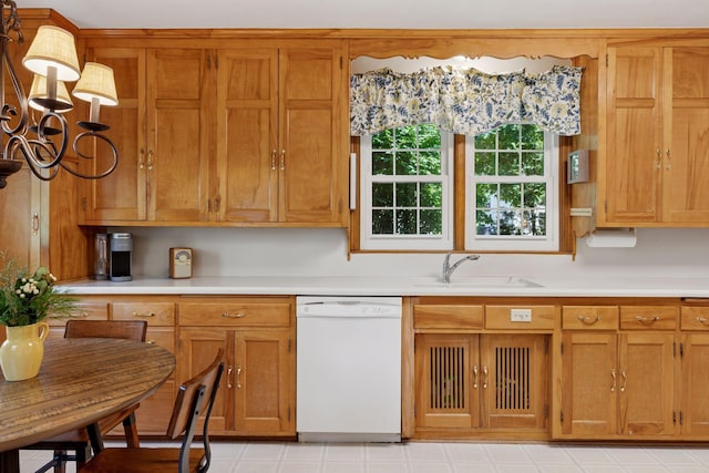 1804 Pinehurst Ave, Saint Paul, MN 55116 - kitchen with dishwasher, light countertops, brown cabinets, and a chandelier