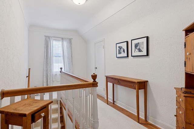 1804 Pinehurst Ave, Saint Paul, MN 55116 - corridor with an upstairs landing, wood finished floors, vaulted ceiling, and a textured wall