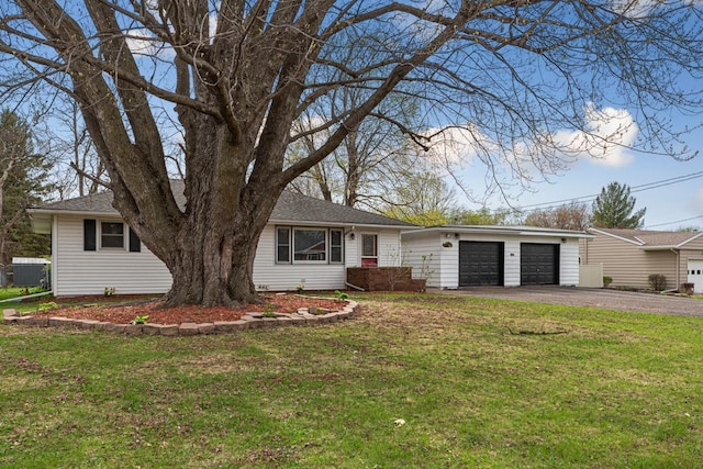 ranch-style house featuring a front yard, a garage, and driveway