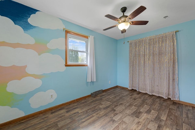 unfurnished room with baseboards, visible vents, a ceiling fan, and wood finished floors