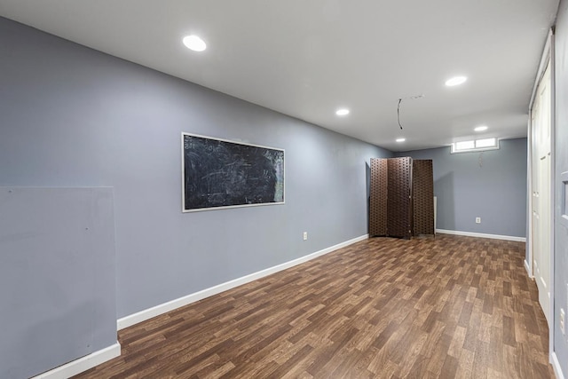 basement featuring recessed lighting, baseboards, and wood finished floors