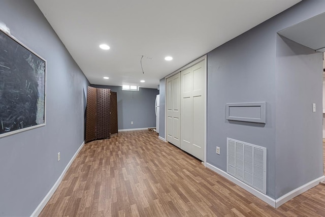 basement with baseboards, recessed lighting, visible vents, and wood finished floors