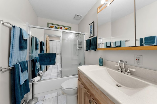 full bath featuring tile patterned floors, toilet, visible vents, vanity, and enclosed tub / shower combo