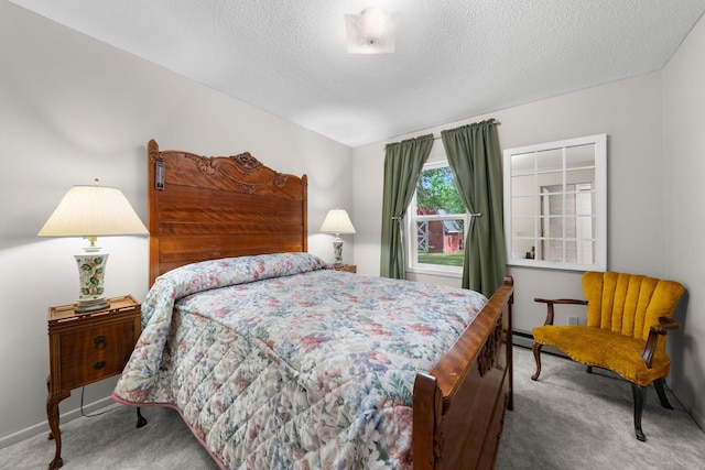 carpeted bedroom featuring baseboards and a textured ceiling