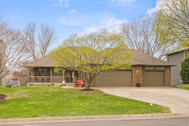 view of front of property with covered porch, brick siding, a front lawn, concrete driveway, and an attached garage