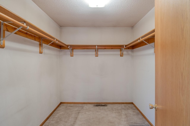 spacious closet with visible vents and carpet flooring