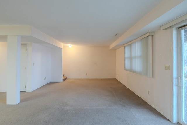 carpeted spare room featuring baseboards