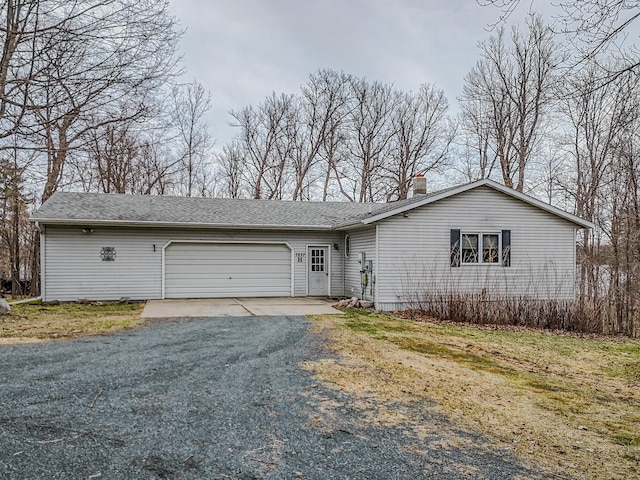 ranch-style home featuring an attached garage, a shingled roof, aphalt driveway, and a chimney