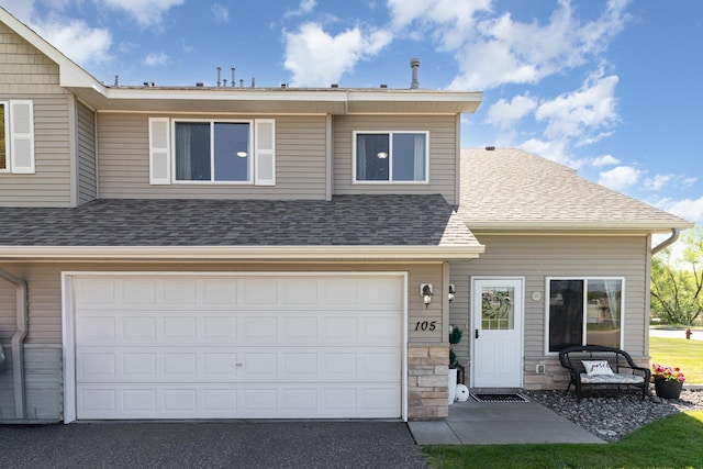 3831 232nd Ave NW Unit 105, Saint Francis, MN 55070 - view of property with a shingled roof, a garage, and driveway