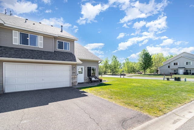 3831 232nd Ave NW Unit 105, Saint Francis, MN 55070 - view of front of property featuring a front lawn, roof with shingles, asphalt driveway, stone siding, and a garage