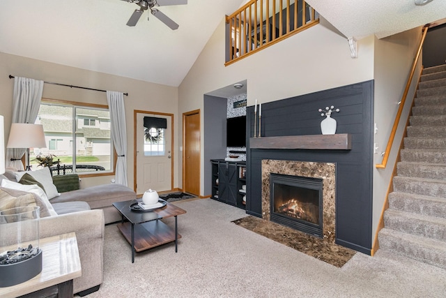 3831 232nd Ave NW Unit 105, Saint Francis, MN 55070 - living room featuring stairs, ceiling fan, a premium fireplace, carpet floors, and high vaulted ceiling