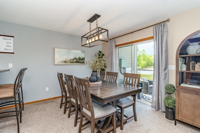 3831 232nd Ave NW Unit 105, Saint Francis, MN 55070 - dining room featuring light colored carpet, a chandelier, baseboards, and a textured ceiling