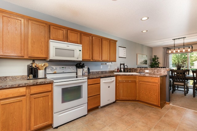 3831 232nd Ave NW Unit 105, Saint Francis, MN 55070 - kitchen featuring white appliances, a peninsula, a sink, recessed lighting, and brown cabinets