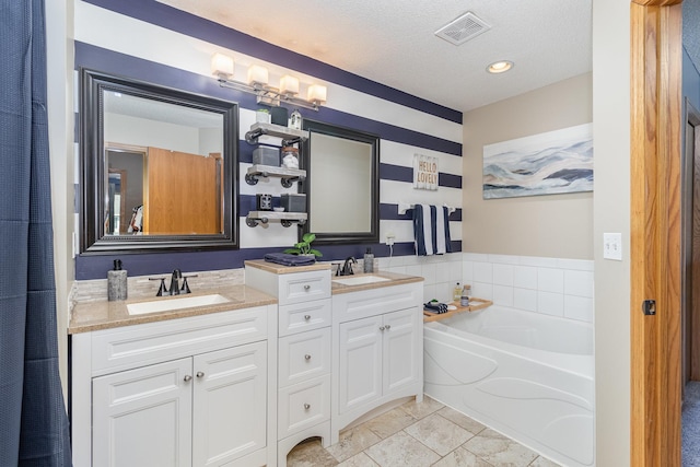 3831 232nd Ave NW Unit 105, Saint Francis, MN 55070 - full bathroom with double vanity, a bath, and a textured ceiling