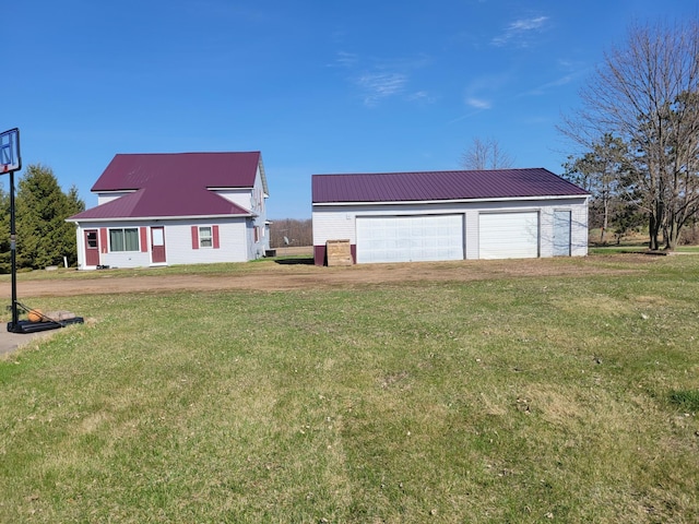 exterior space with dirt driveway, an outdoor structure, and a garage