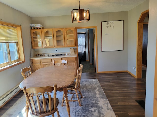 dining room featuring baseboards, a notable chandelier, a baseboard radiator, and dark wood-style flooring