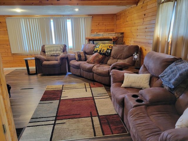 living room with recessed lighting, wooden walls, wood finished floors, visible vents, and a fireplace