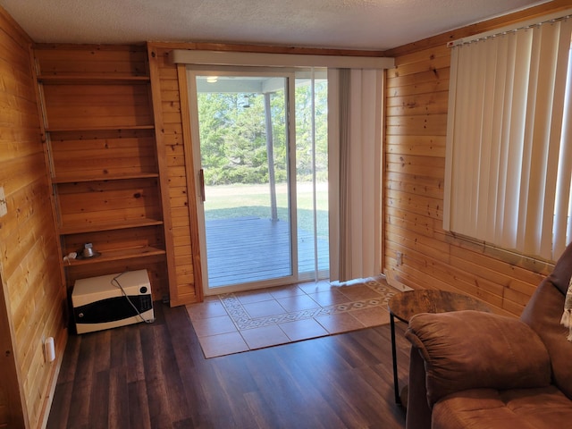 entryway with wood finished floors and wood walls