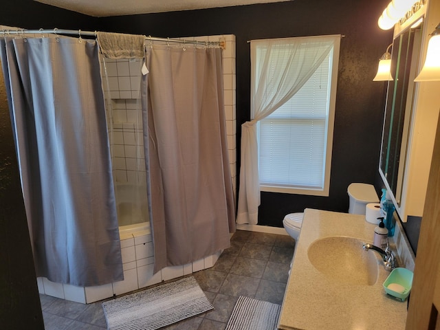 bathroom with shower / tub combo, vanity, tile patterned flooring, and toilet