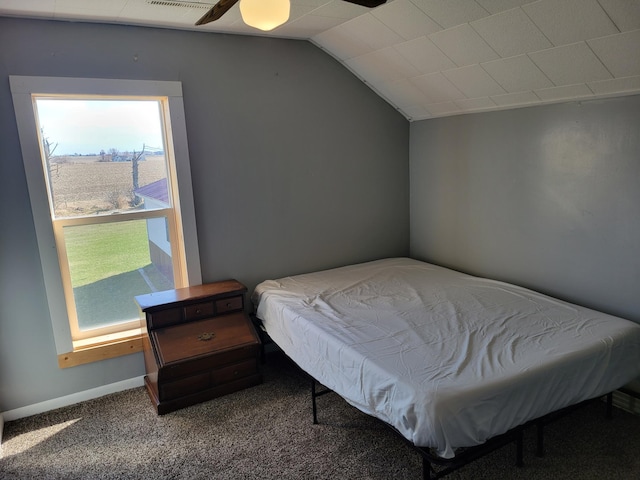carpeted bedroom with lofted ceiling, baseboards, and ceiling fan