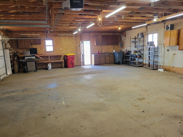 garage with a garage door opener and a workshop area