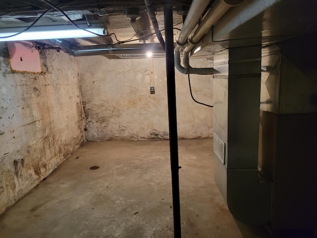 unfinished below grade area featuring heating unit