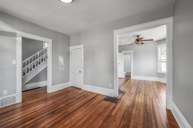 1527 Minnehaha Ave W, Saint Paul, MN 55104 - unfurnished living room with stairs, ceiling fan, wood-type flooring, baseboards, and visible vents