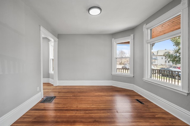 1527 Minnehaha Ave W, Saint Paul, MN 55104 - spare room featuring visible vents, baseboards, wood finished floors, and plenty of natural light