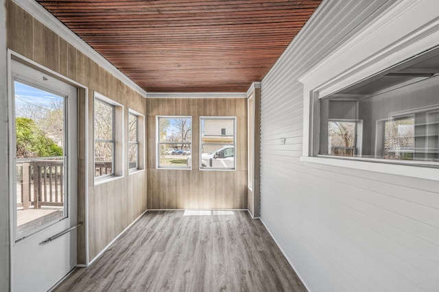 1527 Minnehaha Ave W, Saint Paul, MN 55104 - unfurnished sunroom with wood finished floors, wooden walls, and crown molding