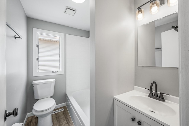 1527 Minnehaha Ave W, Saint Paul, MN 55104 - bathroom featuring toilet, vanity, visible vents, and wood finished floors