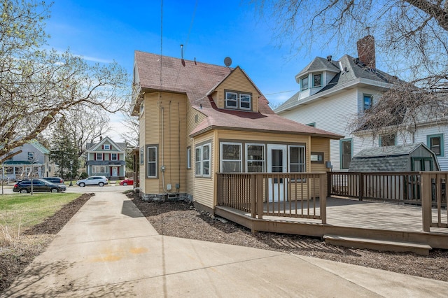 1527 Minnehaha Ave W, Saint Paul, MN 55104 - rear view of house featuring driveway and a deck