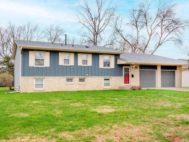 tri-level home with board and batten siding, aphalt driveway, a front yard, brick siding, and a garage