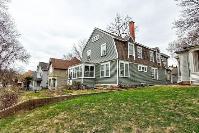 717 3rd St, Red Wing, MN 55066 - back of property with a lawn, a chimney, and a gambrel roof