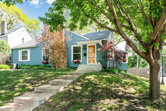 1694 Hillcrest Ave, Saint Paul, MN 55116 - bungalow-style house with a front yard, roof with shingles, and central air condition unit