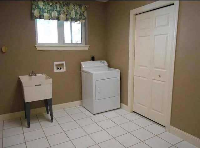 laundry area featuring washer / dryer, light tile patterned flooring, laundry area, and baseboards