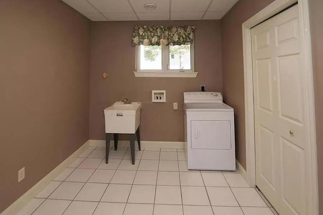 washroom with baseboards, laundry area, washer / clothes dryer, and light tile patterned flooring