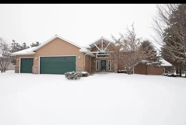 craftsman house with brick siding and an attached garage