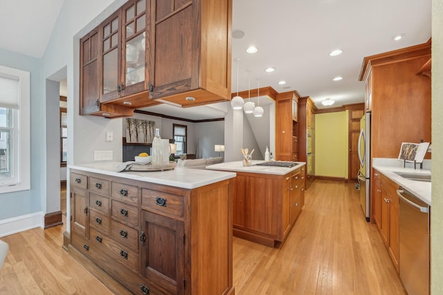 2736 Chowen Ave S, Minneapolis, MN 55416 - kitchen with brown cabinets, appliances with stainless steel finishes, light wood-style floors, light countertops, and glass insert cabinets