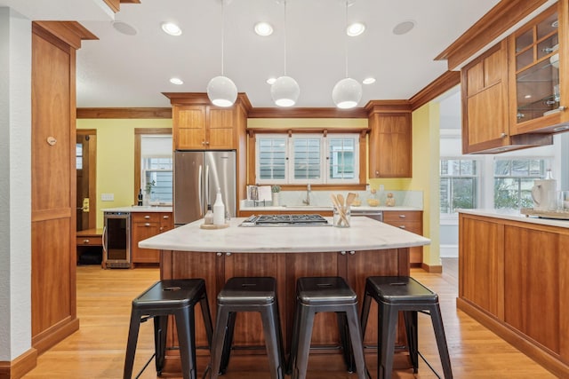 2736 Chowen Ave S, Minneapolis, MN 55416 - kitchen with appliances with stainless steel finishes, a kitchen breakfast bar, brown cabinets, and beverage cooler