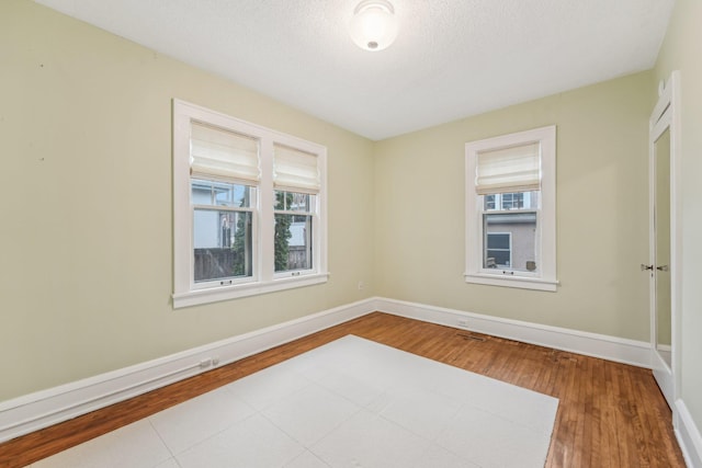 2736 Chowen Ave S, Minneapolis, MN 55416 - spare room featuring baseboards, wood finished floors, and a wealth of natural light