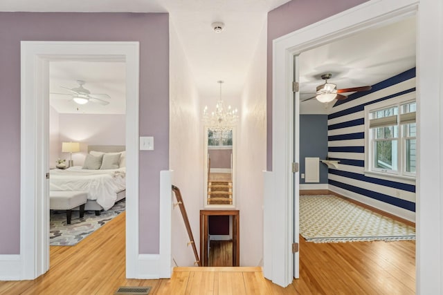 2736 Chowen Ave S, Minneapolis, MN 55416 - corridor with baseboards, visible vents, wood finished floors, and a notable chandelier