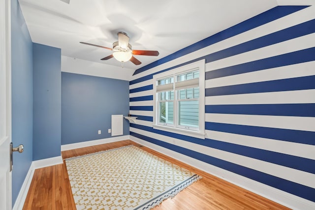 2736 Chowen Ave S, Minneapolis, MN 55416 - spare room with baseboards, a ceiling fan, wood finished floors, and wallpapered walls