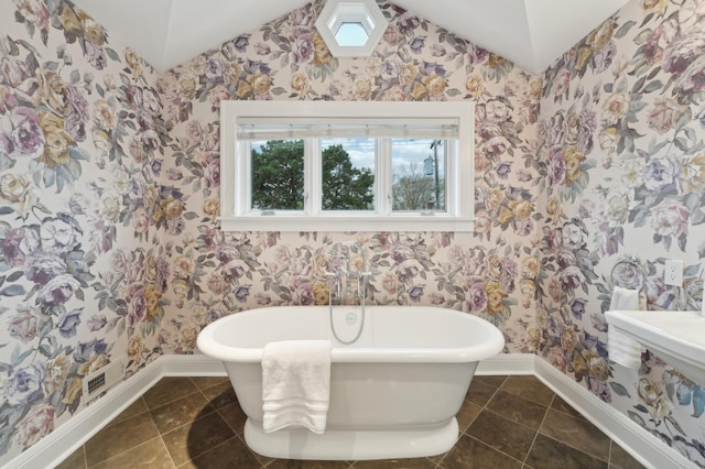2736 Chowen Ave S, Minneapolis, MN 55416 - full bathroom featuring baseboards, a soaking tub, wallpapered walls, and lofted ceiling