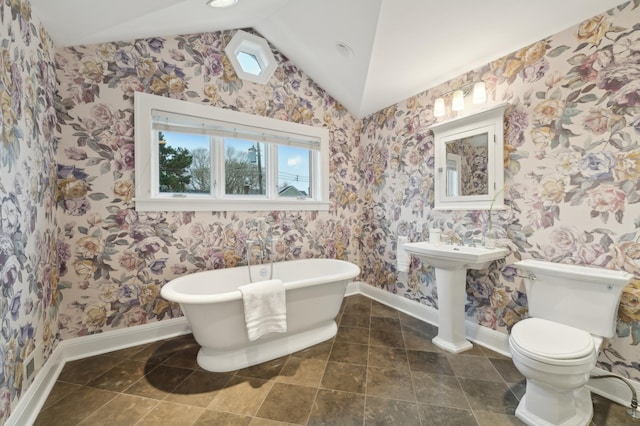 2736 Chowen Ave S, Minneapolis, MN 55416 - bathroom featuring toilet, baseboards, wallpapered walls, a freestanding bath, and vaulted ceiling
