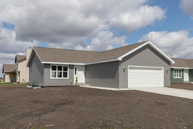 231 Julia St, Claremont, MN 55924 - ranch-style house featuring an attached garage, driveway, and roof with shingles