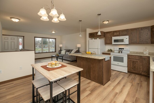 231 Julia St, Claremont, MN 55924 - kitchen with an inviting chandelier, white appliances, dark brown cabinetry, light wood-style flooring, and hanging light fixtures