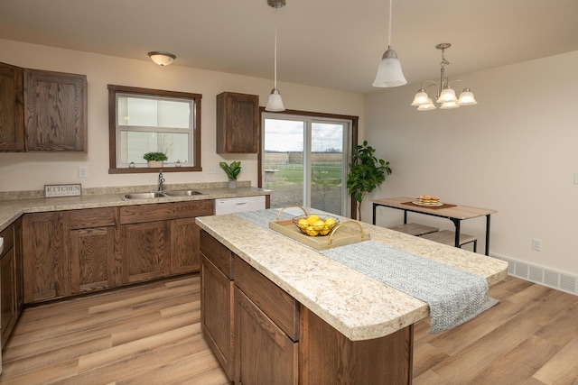 231 Julia St, Claremont, MN 55924 - kitchen with light wood-type flooring, light countertops, visible vents, and a sink