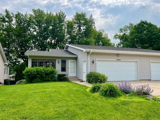 1204 Lia Dr, Northfield, MN 55057 - view of front facade featuring a garage, a front yard, and driveway