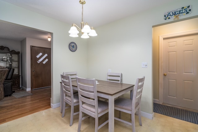 1001 Alexander St, Crookston, MN 56716 - dining space featuring light floors, baseboards, and a chandelier
